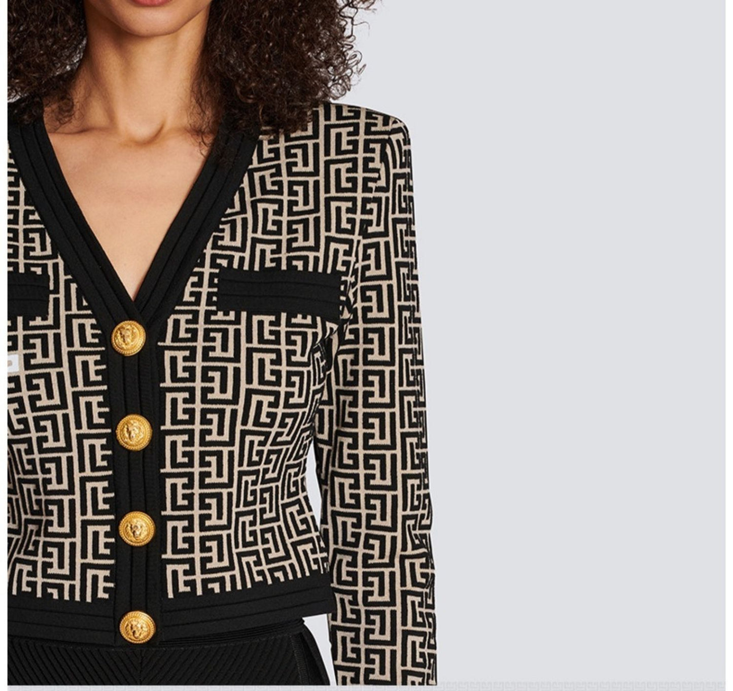 This is a slim knitted metal-buttoned cardigan