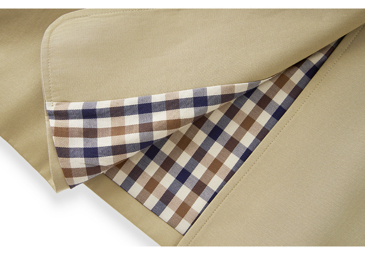 25ss A long, loose coat with a British check patchwork lapel